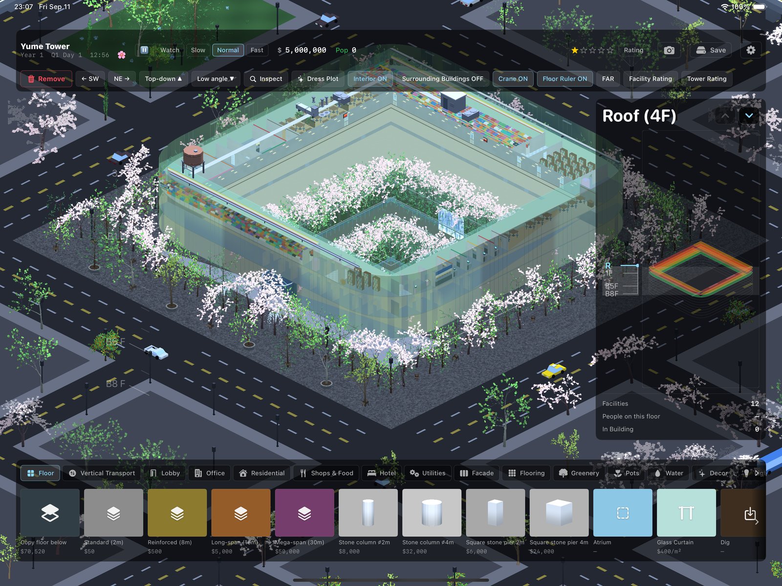 A sunken cherry-blossom garden courtyard surrounded by office desks