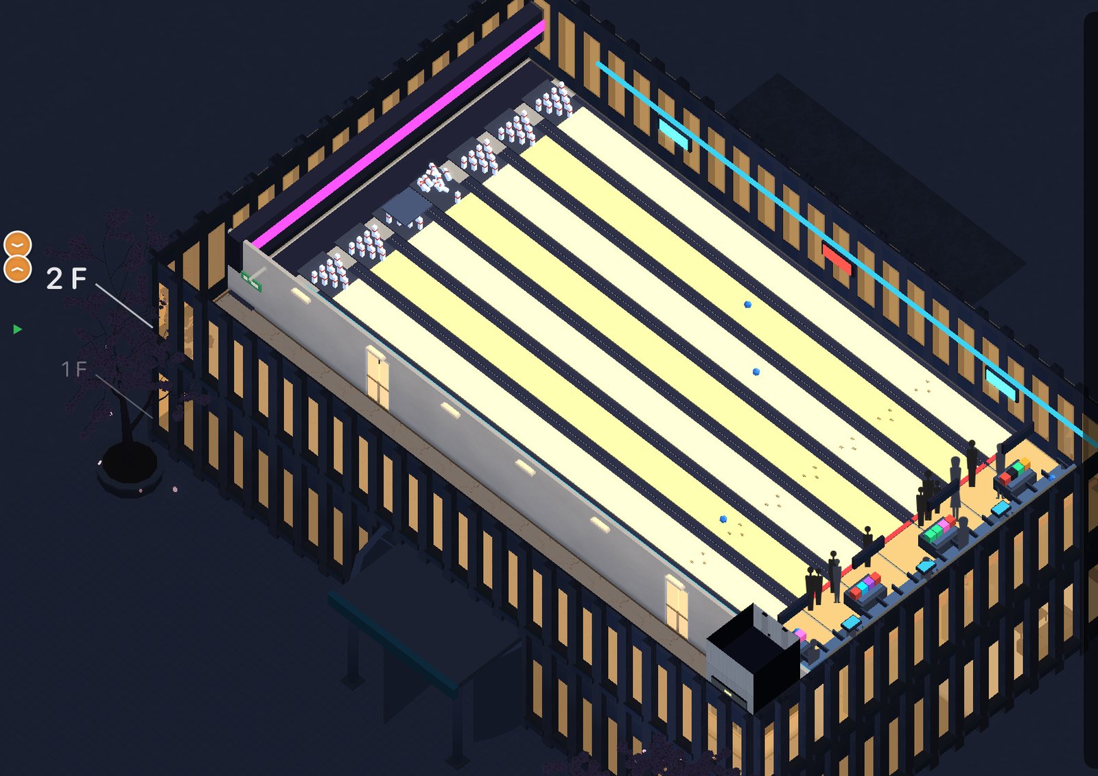 A bowling alley floor at night: lit lanes, seating, and a crowd of guests